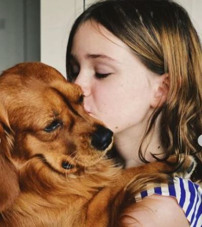 Arlo Mertz embracing her pet dog Arthur