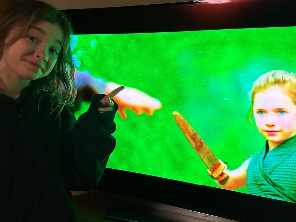 Robyn Points At Her Character Kit From The Disney Show Willow